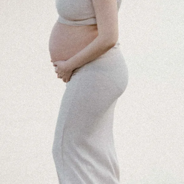 Hands cradling a pregnant belly